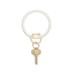 a white keychain with a gold ring and two keys hanging from the end