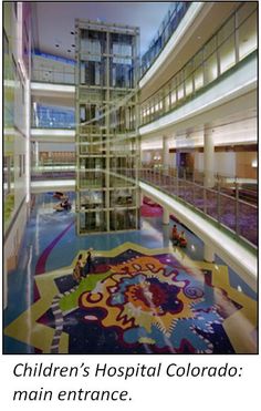 the inside of a large building with colorful carpeting and glass balconies on each floor