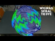 an image of a blue and green object on a table with the words wigwag spiral tie dye