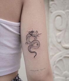 a woman with a dragon tattoo on her arm