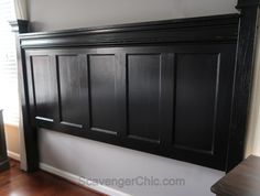 a black headboard in the corner of a room