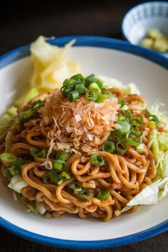 a white plate topped with noodles and veggies