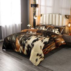 a bed with animal print comforter and pillows