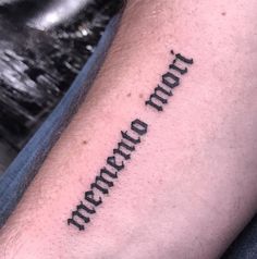 a man's arm with the word tattoo on it