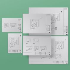 four white papers with drawings on them sitting next to each other in front of a green background