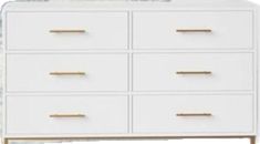 a white dresser with gold handles and drawers