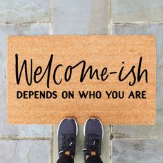 someone is standing in front of a welcome mat that says,'welcome - fish defends on who you are '