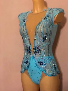 a mannequin wearing a blue bodysuit with sequins and beads on it