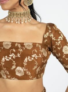 June 2024 Drop. Square Neck. Square Back. Half-Sleeve. Soft Brocade Fabric Composition. This blouse cut is 2" shorter than our standard blouses. “This classic brocade pattern is back and better than ever!”” - Sofi Kassam, Co-Founder & Designer Introducing our Copper Dahlia Blouse, a timeless expression of grace and tradition. Adorned with a delicate gold floral pattern that elegantly graces its fabric, this blouse captures the essence of classic beauty. Crafted from soft brocade fabric, it exude Square Neck Blouses For Sarees, One Sleeve Blouse Design, Blouse Designs Latest Half Sleeve, Sleeves Patterns For Blouses, Wide Square Neck Saree Blouse, Blouse Neck Back Designs, Half Sleeve Blouse Design Saree, Neck Patterns For Blouses, Blouse Designs Onam