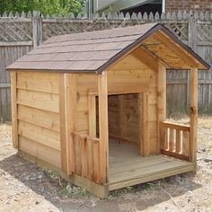 a small wooden dog house in the yard