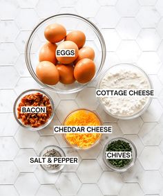 eggs, cottage cheese, cheddar cheese, salt and pepper in bowls on a marble countertop