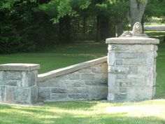 an old stone wall and gate in a park