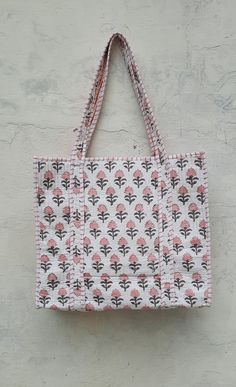 The Indian Hand Block Printed Cotton Quilted Women's Handbags from Rajasthan India. This Handbag is completely Indian Printed on good quality cotton. Cotton quilted travel Bag made by Indian Artisans, this cotton quilted shopping bag is totally unique and multi purpose. Use this for your grocery or as a travel bag. Perfect to suit all. Perfect Gift For her Item :- Cotton Handbag Material: 100% Cotton Pattern: Floral Print Was Care - Home Washable Style: Tote Bag Tote Bag -  Color - (Pink Buti ) Traditional Pink Tote Bag, Bohemian Rectangular Canvas Shopping Bag, Bohemian Style Rectangular Canvas Shopping Bag, Bohemian Rectangular Shopping Bag, Bohemian Rectangular Canvas Bag For Daily Use, Traditional White Tote Bag, Bohemian Rectangular Canvas Bag, Pink Square Bohemian Shoulder Bag, White Bohemian Bag With Double Handle