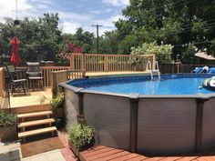 an above ground pool surrounded by wooden decking