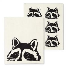 two napkins with black and white pictures of raccoons