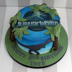 a birthday cake is decorated with an image of a dinosaur