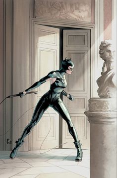 a woman dressed as catwoman in front of a statue