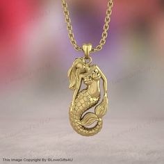 Dive into enchantment with our Gold Mermaid Necklace. This captivating piece features a detailed mermaid charm pendant, crafted from high-quality solid gold. Perfect for ocean lovers, this necklace embodies the mystique and magic of the sea, making it a timeless accessory that adds a touch of whimsy to any outfit. Experience the magic of the ocean with our Gold Mermaid Necklace, a beautifully crafted piece that celebrates the allure of mermaid folklore. The intricate gold mermaid charm pendant c Gold Mermaid, Ocean Inspired Jewelry, Mermaid Gifts, Mermaid Necklace, Timeless Accessories, Ocean Inspiration, Charm Pendant, Solid Gold, Gold Jewelry