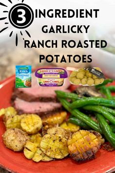 a red plate topped with meat and green beans next to potatoes on a counter top