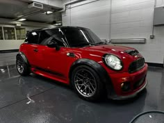 a small red car parked in a garage