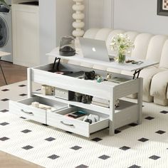 a living room filled with furniture and a laptop computer on top of a coffee table