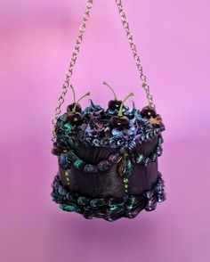 Indulge in gothic elegance with this iridescent cake purse! Crafted in rich black with shimmering iridescent accents and rhinestones, this unique bag is the perfect blend of dark romance and whimsical charm.  Spacious yet compact, it's an ideal statement piece for gothic fashion lovers and anyone looking to add a bit of edge to their style. Grab yours now and carry a slice of enchanting mystery wherever you go! DIMENSIONS: ○: 15 cm h: 15 cm WORLDWIDE SHIPPING - This statement purse will turn some the heads, you will rock any event you attend and you will make a sensational impression; - You can wear it in different ways, as a shoulder bag / cross body bag or a purse / clutch (the chain can be easily removed using the lobster clasps);  - It has the necessary space for your mobile phone, cre Cake Purse, Goth Cakes, Goth Purse, Statement Purse, Gothic Cake, Gothic Purse, Funky Purses, Novelty Handbags, Gothic Mode