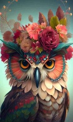 an owl with flowers on its head is wearing a flower crown in front of it's face