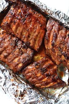 grilled steaks on tin foil with a spoon in the middle, ready to be eaten