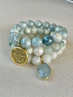 A beautiful set of three bracelets-one aquamarine with pearl focal, one moonstone with aquamarine pendant, and one mystic aquamarine with cross pendant. Spiritual Aquamarine Round Beads Jewelry, Aquamarine Pendant, Cross Pendant, Aquamarine, Moonstone, My Style, Pendant