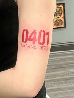 a woman with a tattoo on her arm that reads 1041 kasane teto