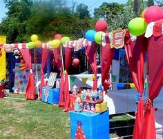 an outdoor event with balloons and decorations