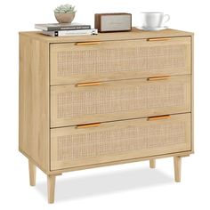 a wooden dresser with wicker drawers and an alarm clock on top of the drawer