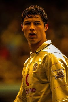 a young man in a yellow uniform is looking at the camera with an intense look on his face