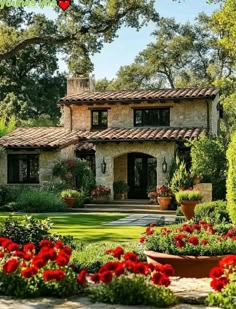 a beautiful house with lots of flowers in the front yard