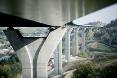 the underside of a large bridge over a river