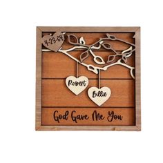 a wooden plaque with two hearts hanging from it's sides and the words god gave me you