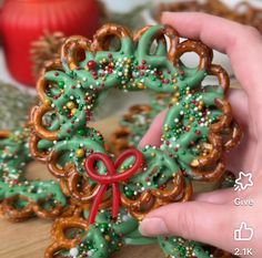 someone is holding some pretzels in front of the camera and making an ornament