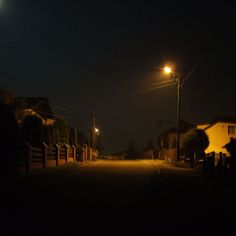 an empty street at night with the light on