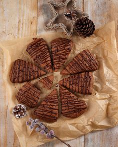 brownies cut into eight pieces on top of a piece of wax paper next to a pine cone