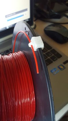 a red cable connected to a laptop computer