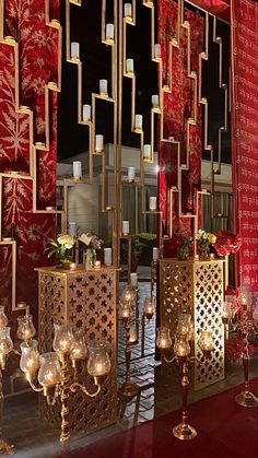 a red and gold wedding set up with candles