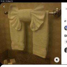 a towel rack with two white towels on it