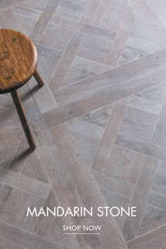 a small wooden table sitting on top of a floor next to a white tiled wall