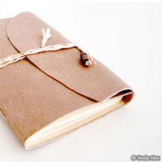 an open brown notebook with a string on it