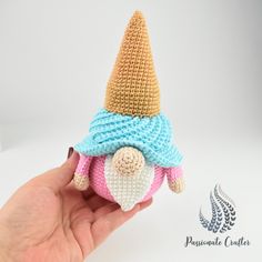 a small crocheted gnome with a knitted hat