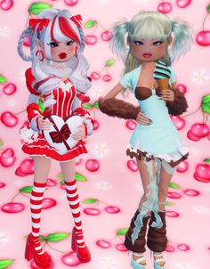 two women dressed in costumes standing next to each other on a pink background with cherries