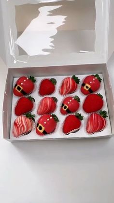 a box filled with chocolate covered strawberries on top of a table