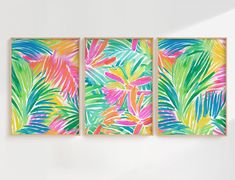 three colorful paintings hanging on the wall