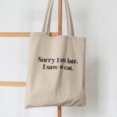 a tote bag that says sorry i'm late, i saw a cat