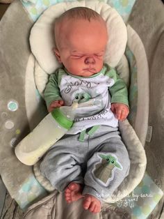 a baby sleeping in a car seat with a pacifier on it's head